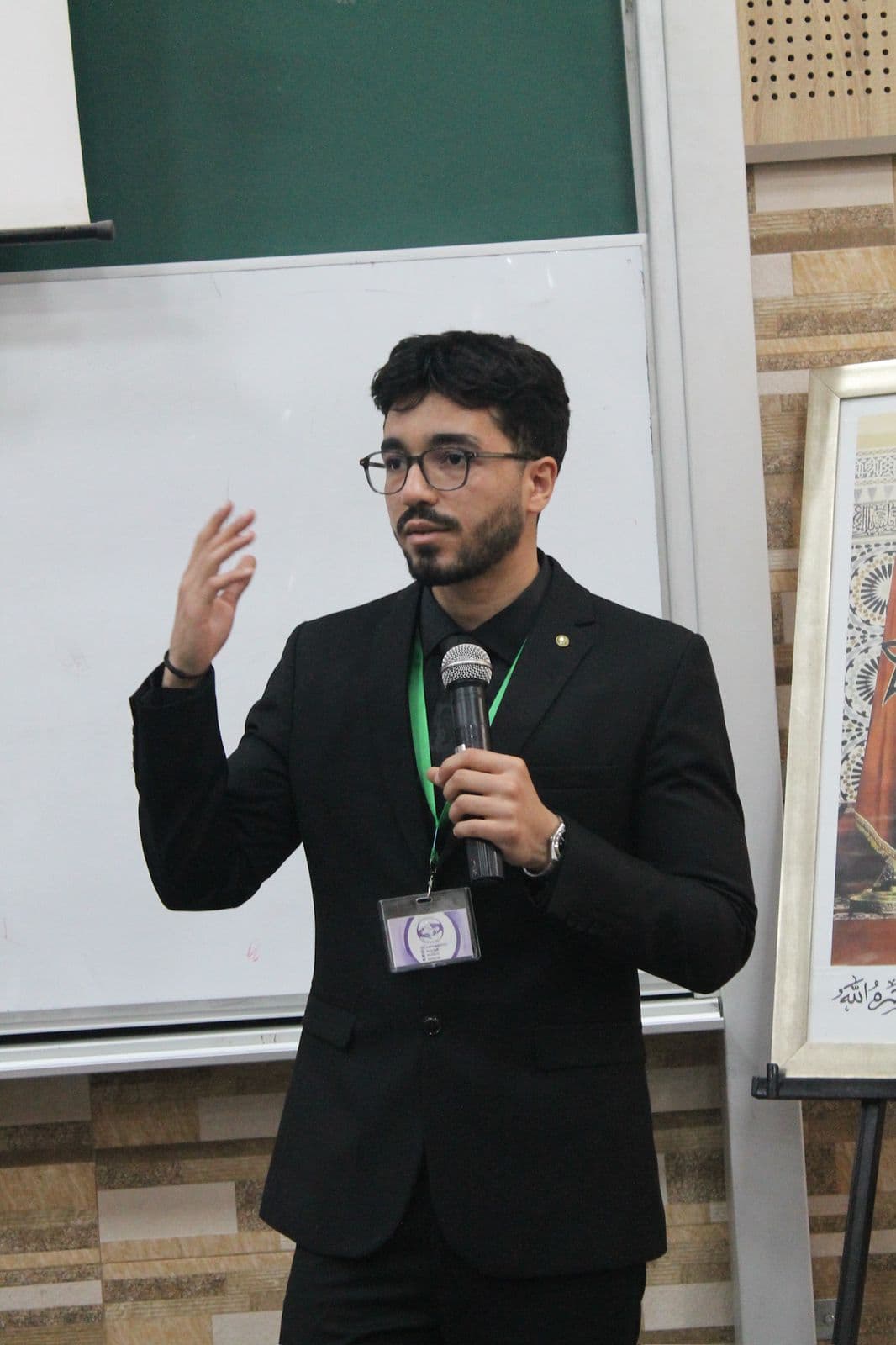 Mohamed Sami Benzaimia, founder of SPARKs, speaking at a scientific event